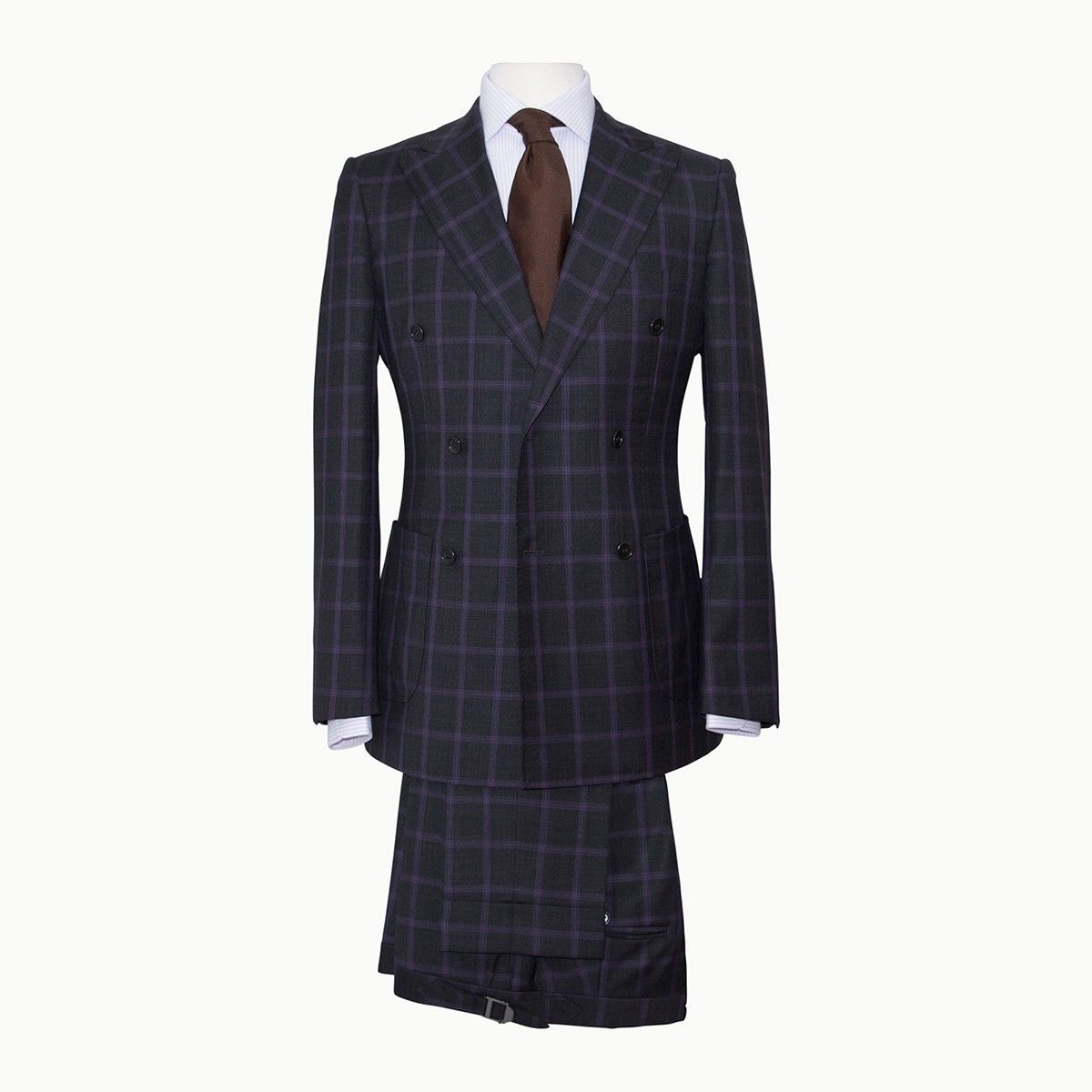 A navy plaid, double-breasted suit jacket with matching trousers, worn with a white dress shirt and brown tie.