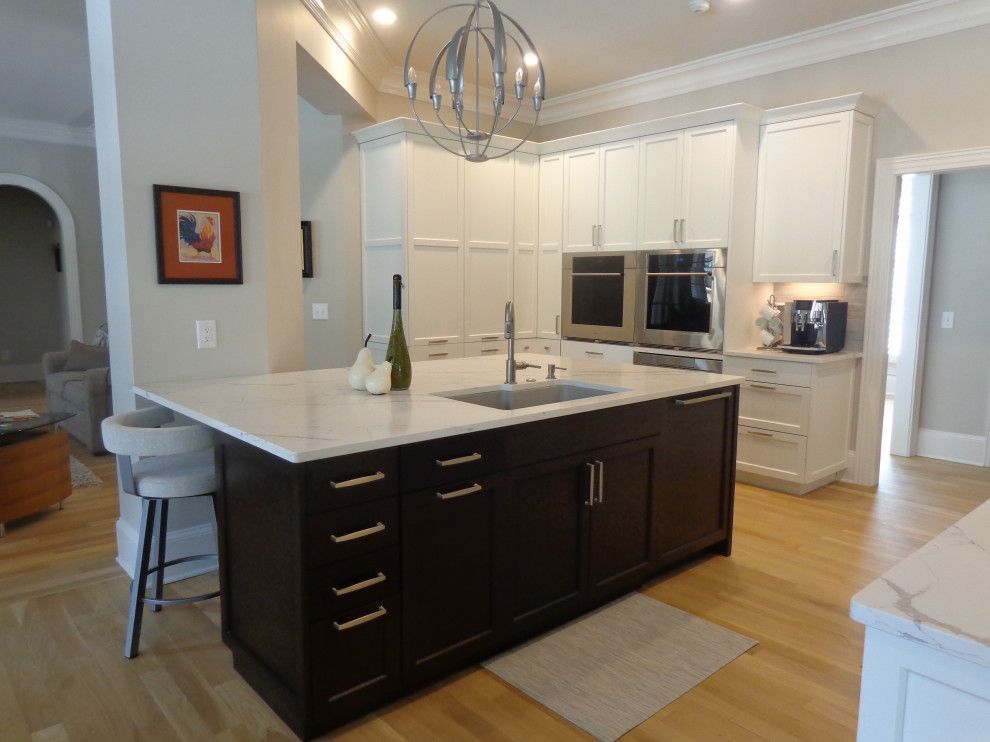 A kitchen with a large island and a sink.