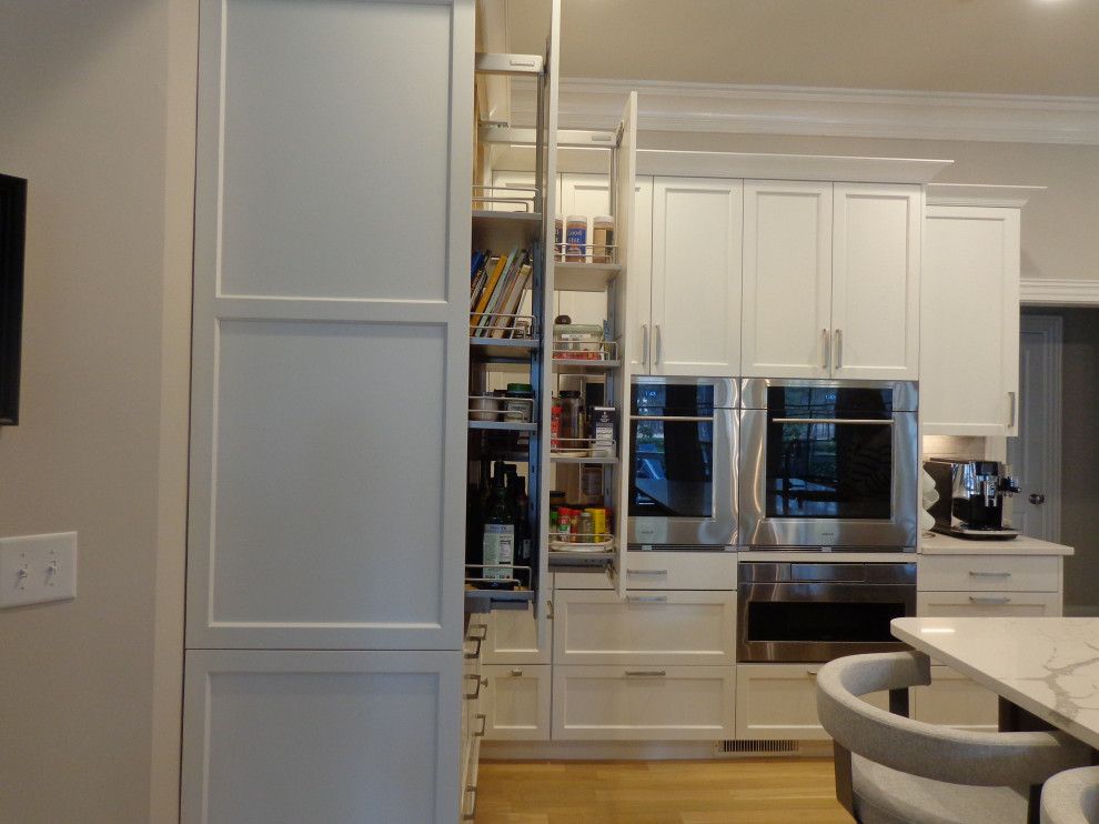 A kitchen with white cabinets and stainless steel appliances.