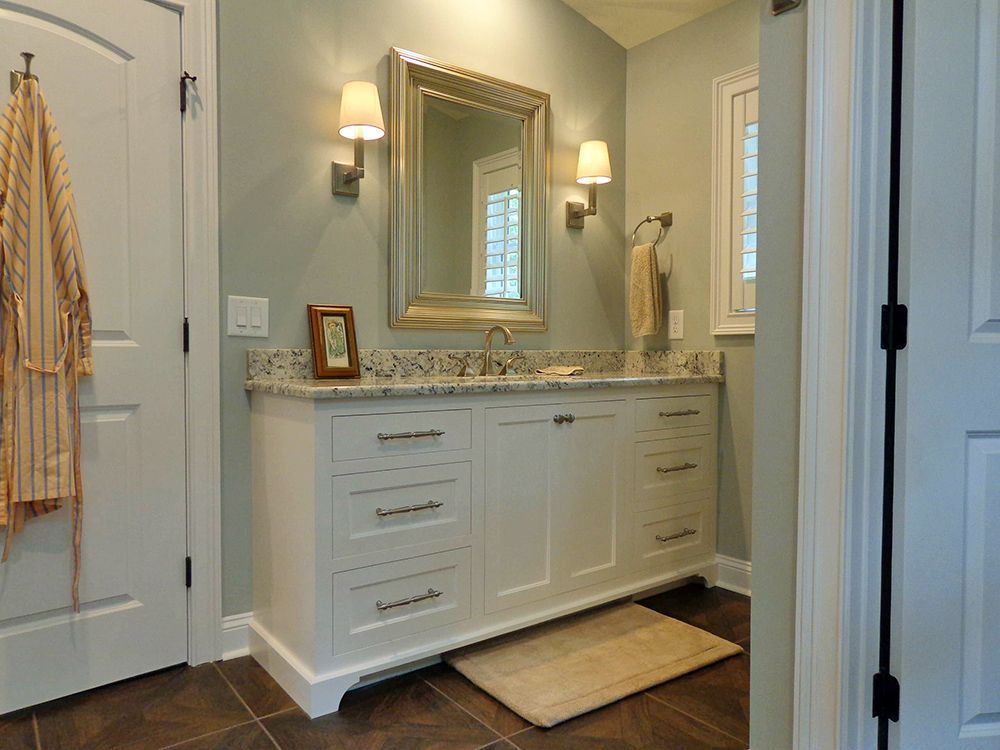 A bathroom with two sinks and a large mirror.