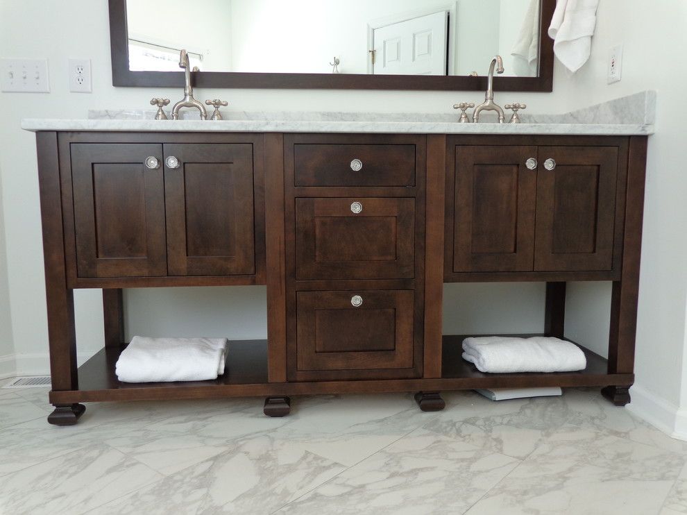 A bathroom vanity with two sinks and a mirror.