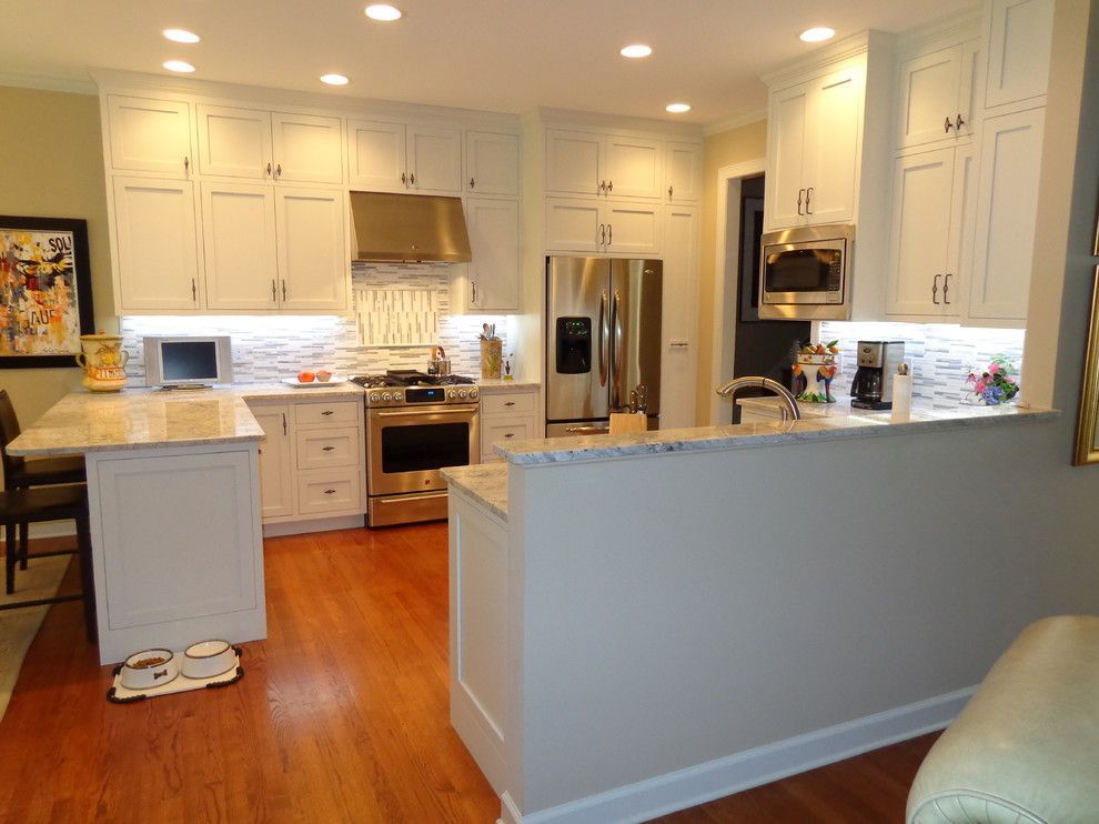 A kitchen with white cabinets and stainless steel appliances.