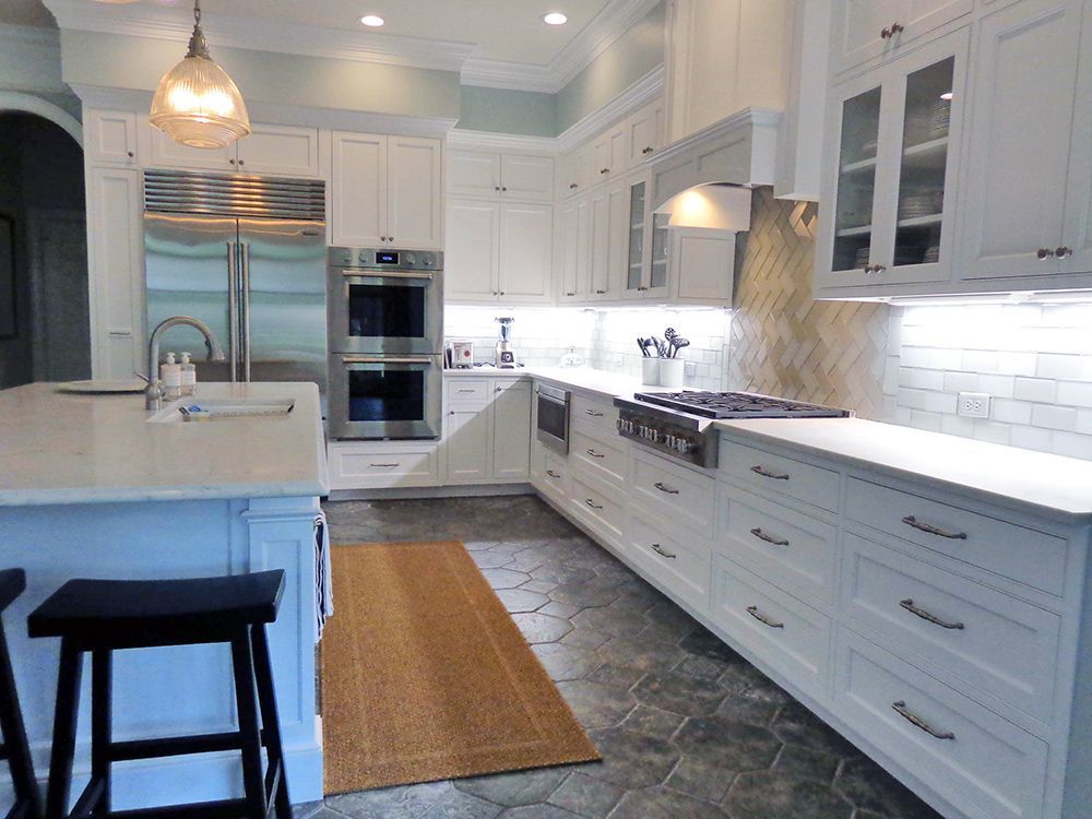 A kitchen with white cabinets and stainless steel appliances.