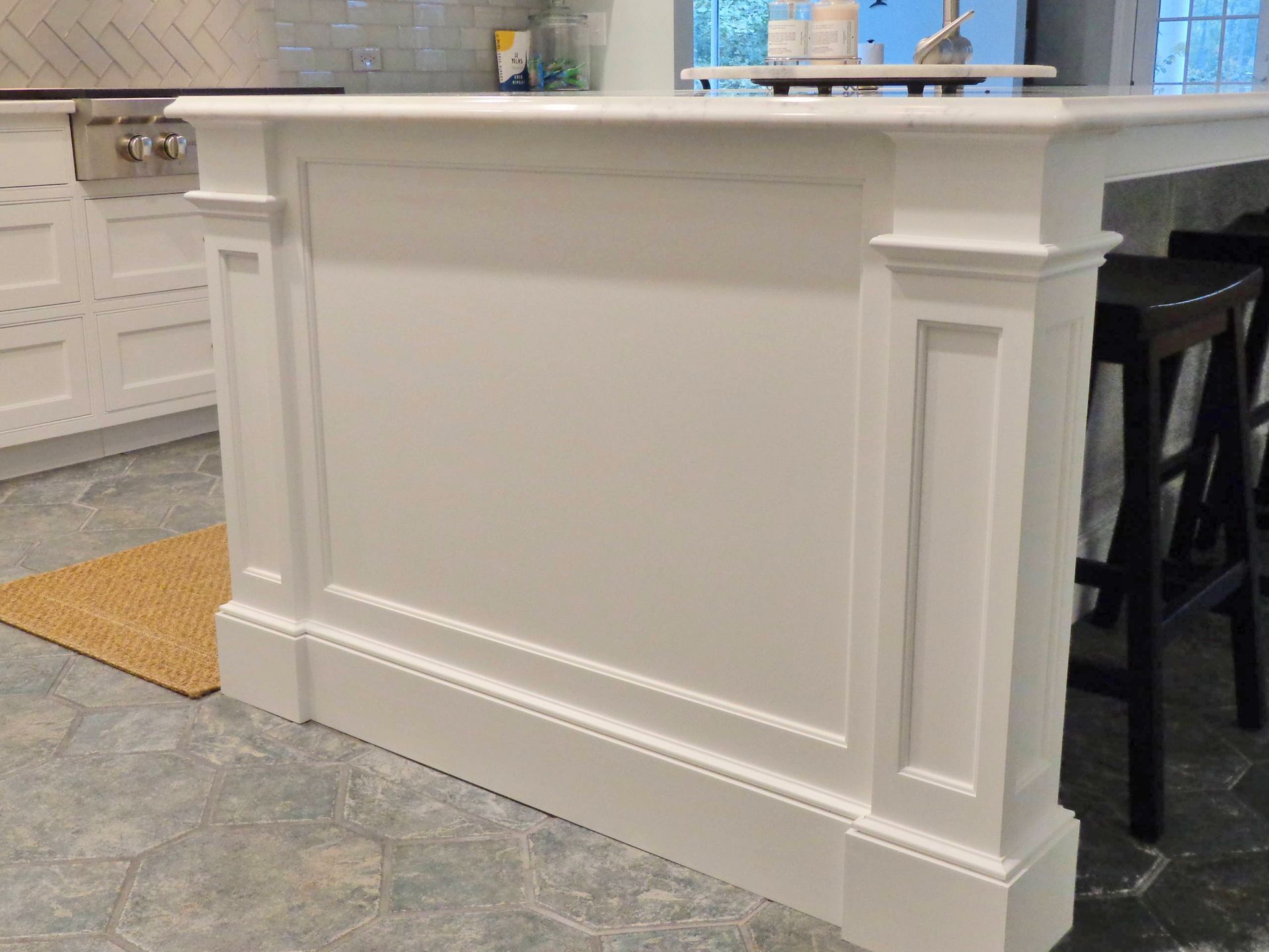 A kitchen with white cabinets and a white counter top.