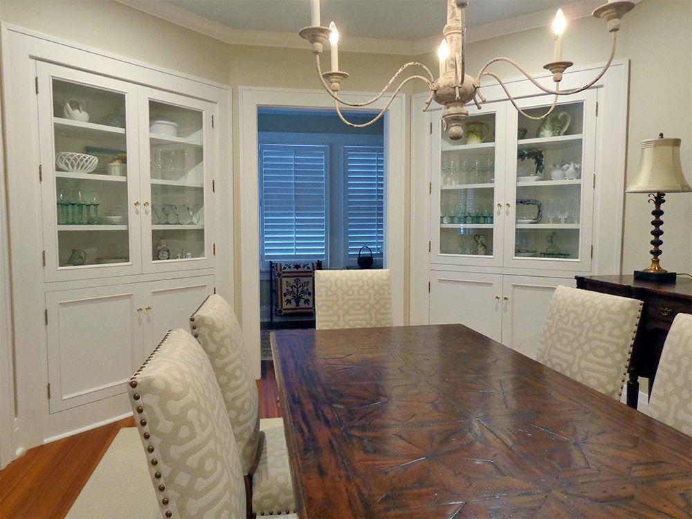 A dining room with a table and chairs and a chandelier.