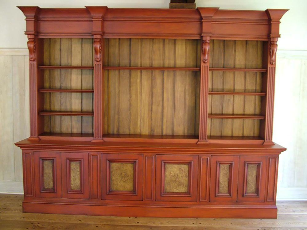 A large wooden bookcase with a lot of shelves.