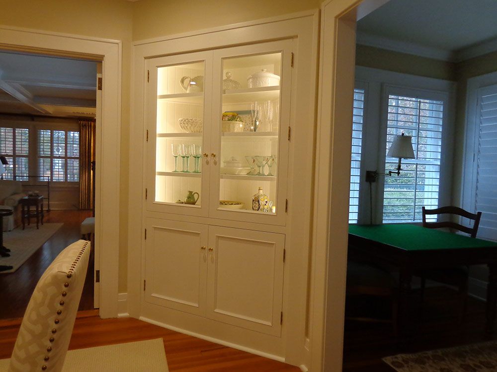A dining room with a hutch and a table.