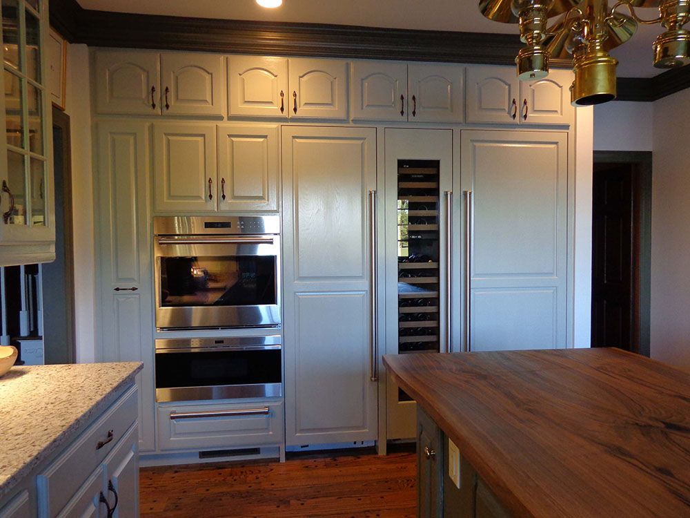 A kitchen with white cabinets and stainless steel appliances.