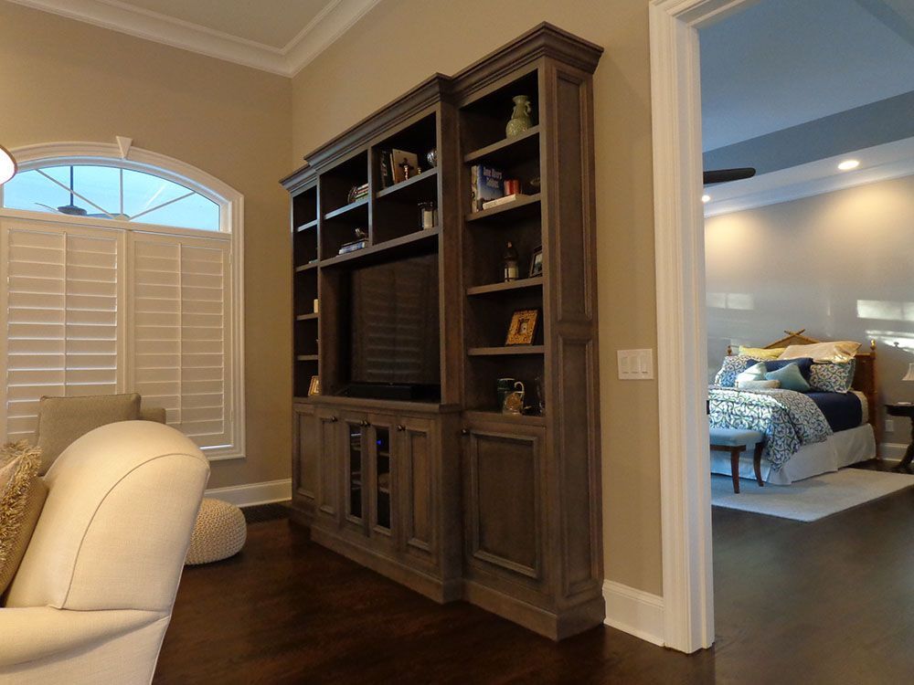 A living room with a large entertainment center and a television.