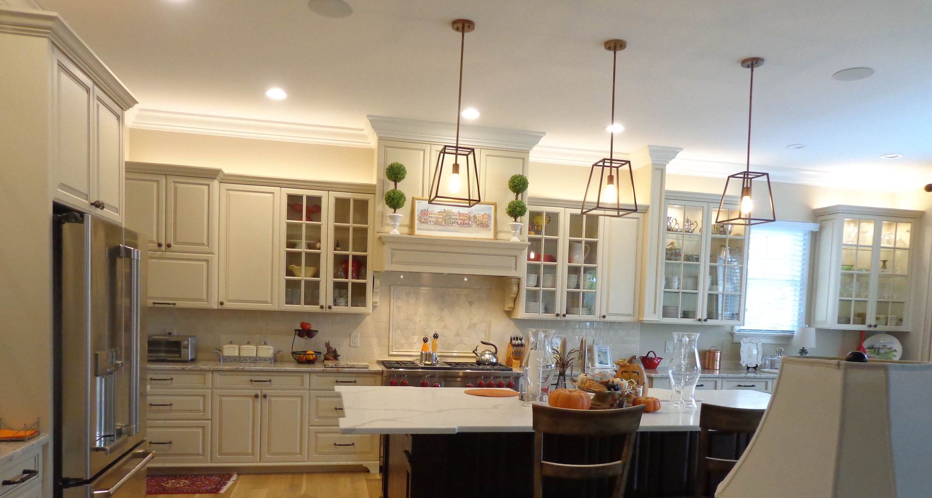 A kitchen with white cabinets and black counter tops