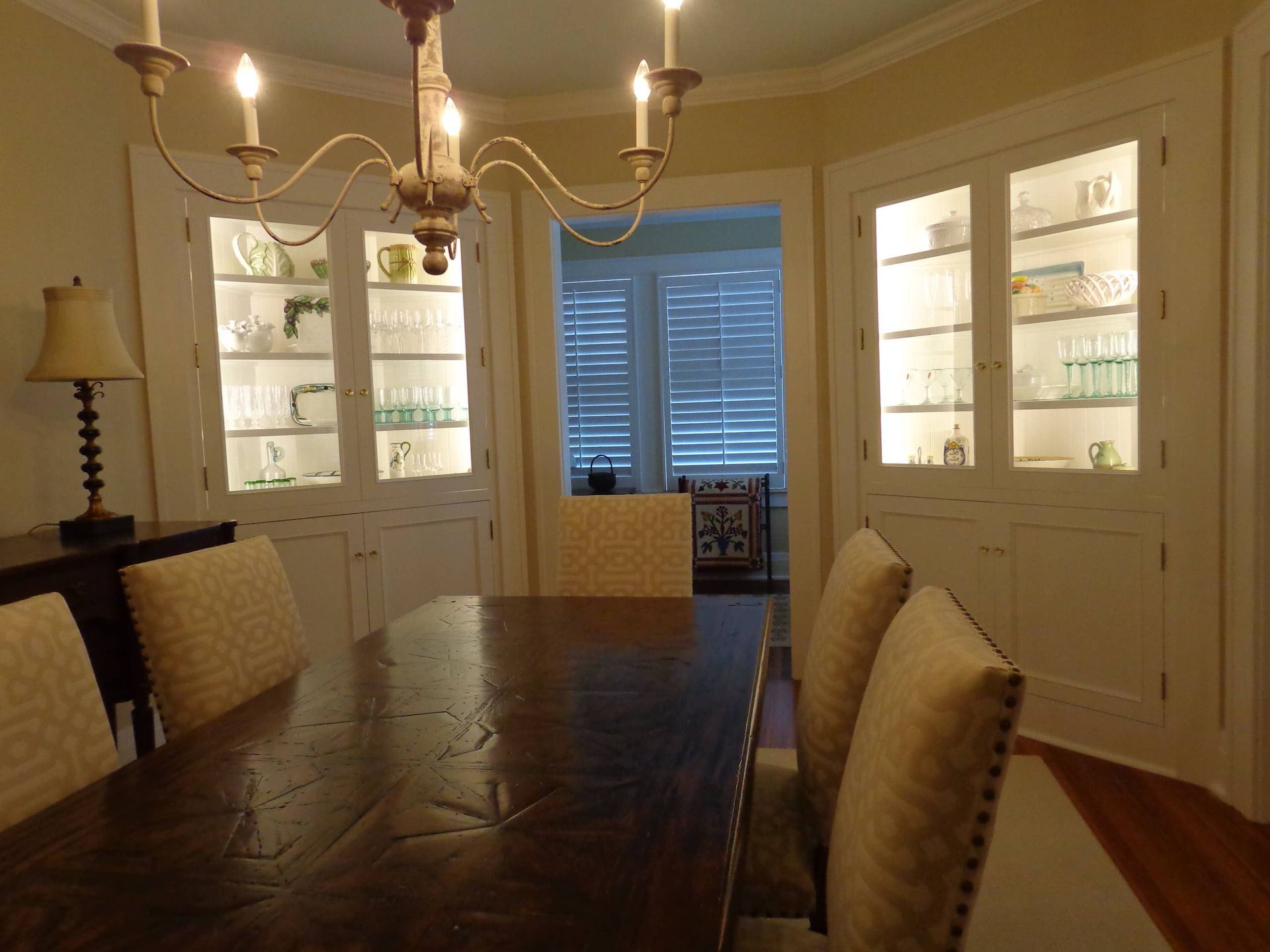 A dining room with a table and chairs and a chandelier