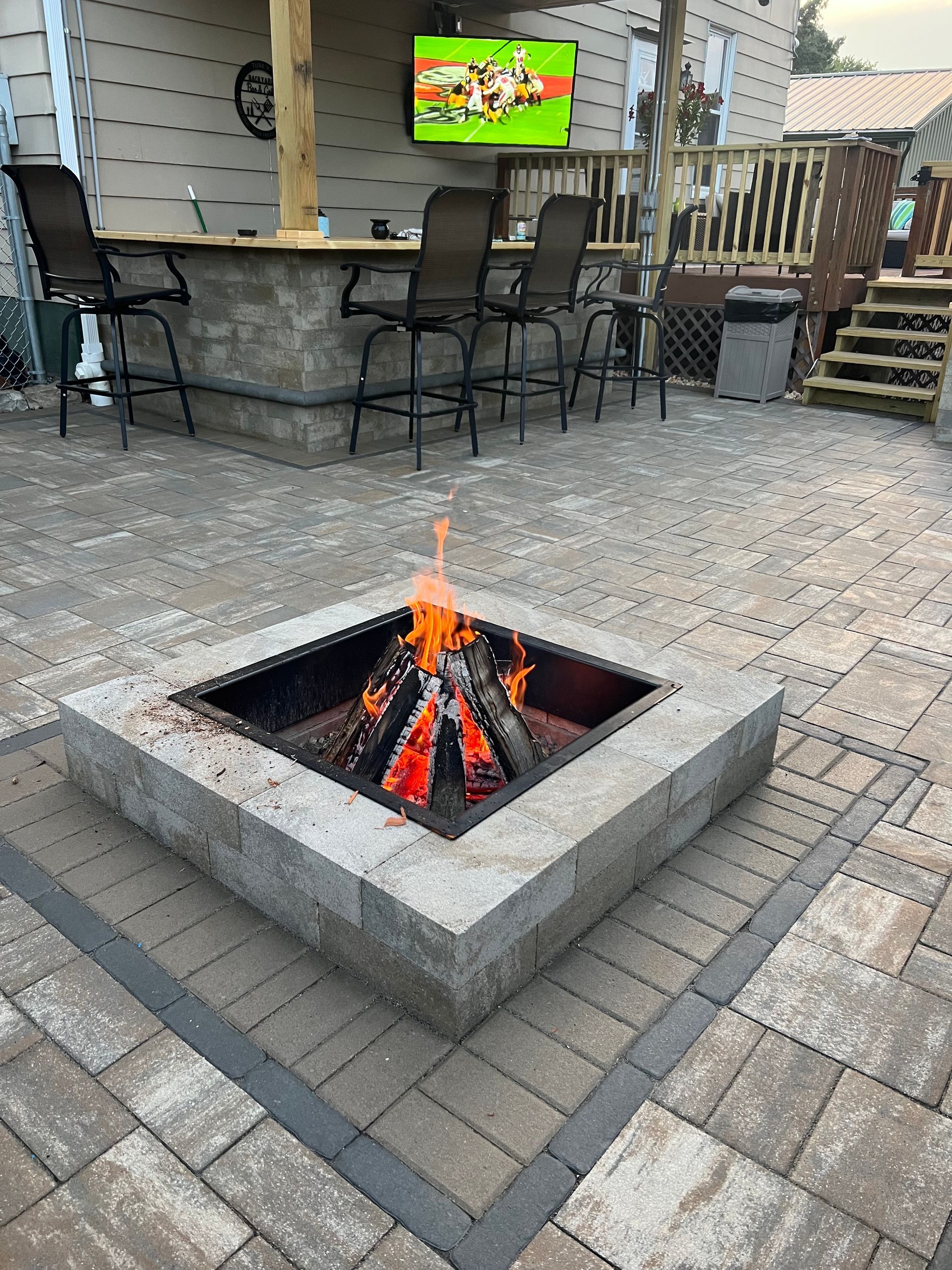 There is a fire pit in the middle of the patio.