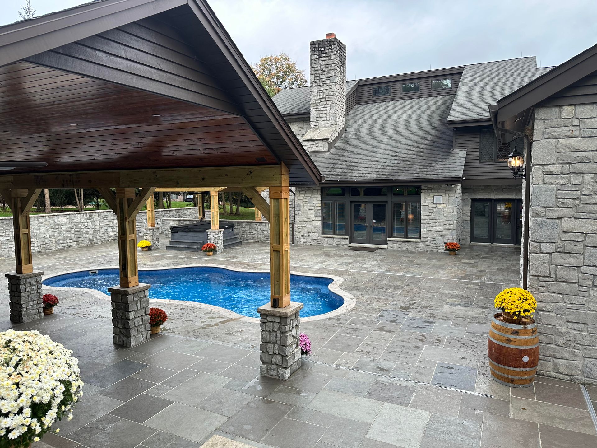 A large house with a swimming pool in front of it.