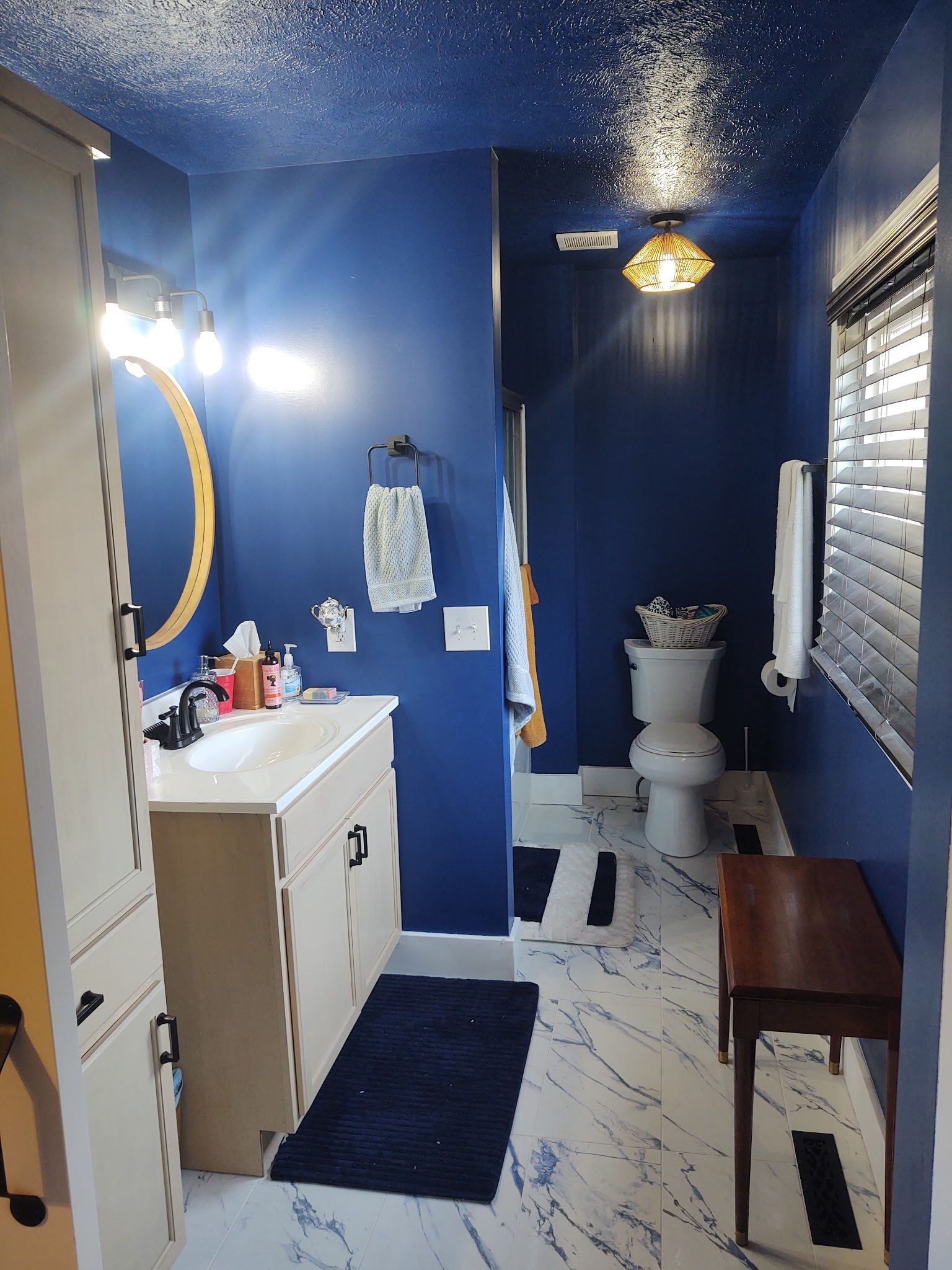 A bathroom with blue walls and a white toilet