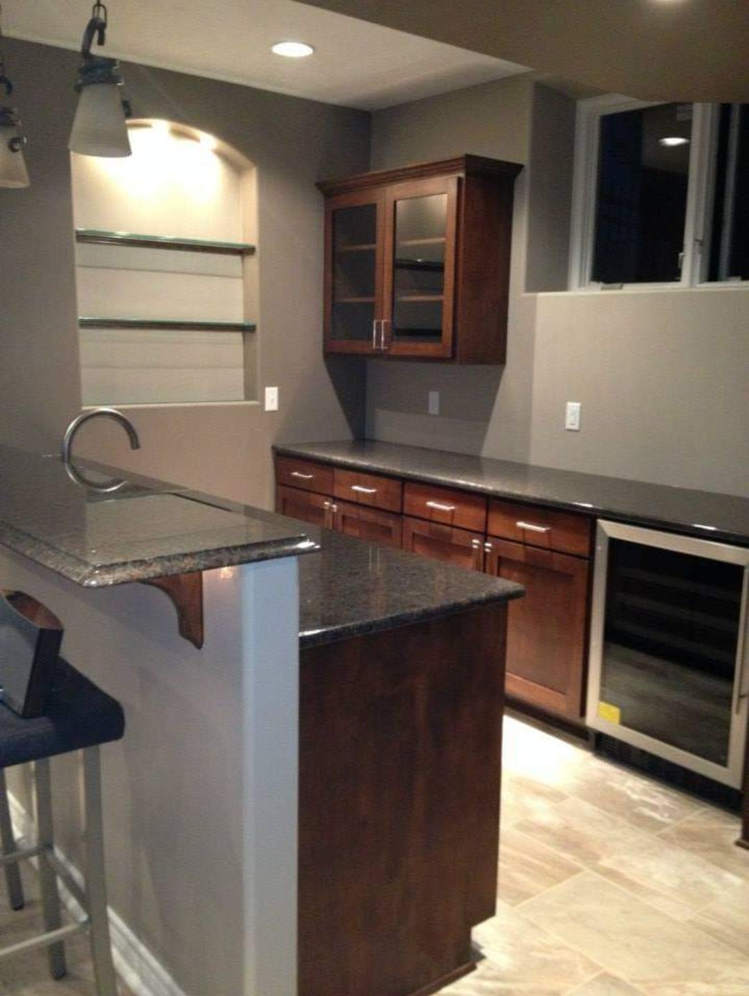 A kitchen with wooden cabinets and granite counter tops