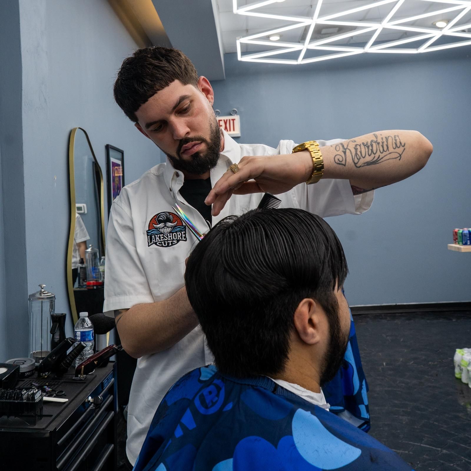 Barber trimming a client's hair in a modern barbershop