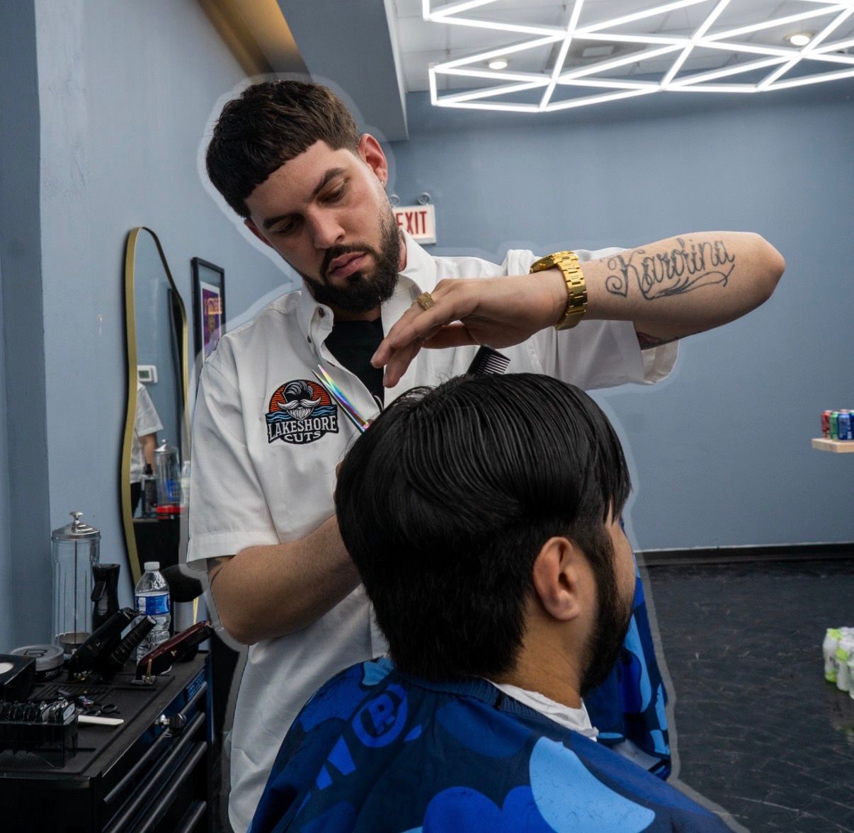Barber trimming a customer’s hair in a modern barbershop