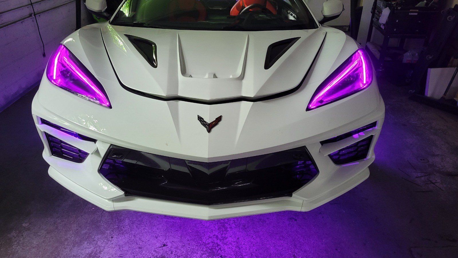 White sports car with pink lights