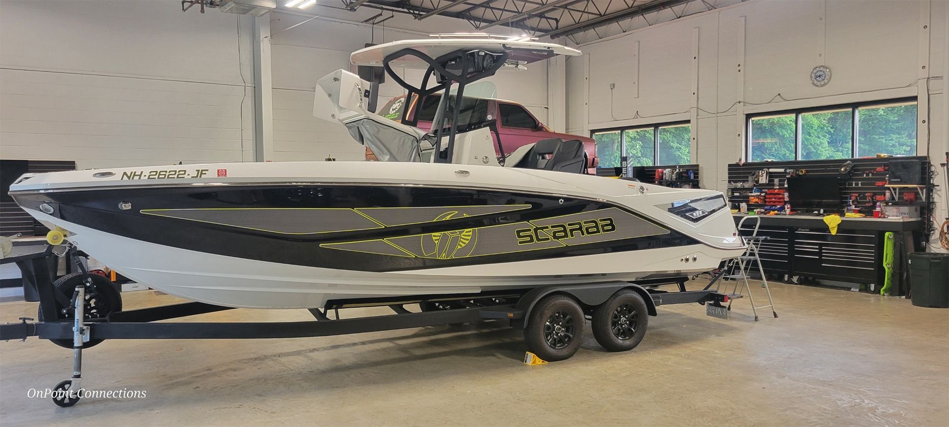 A boat is sitting on a trailer in a garage.