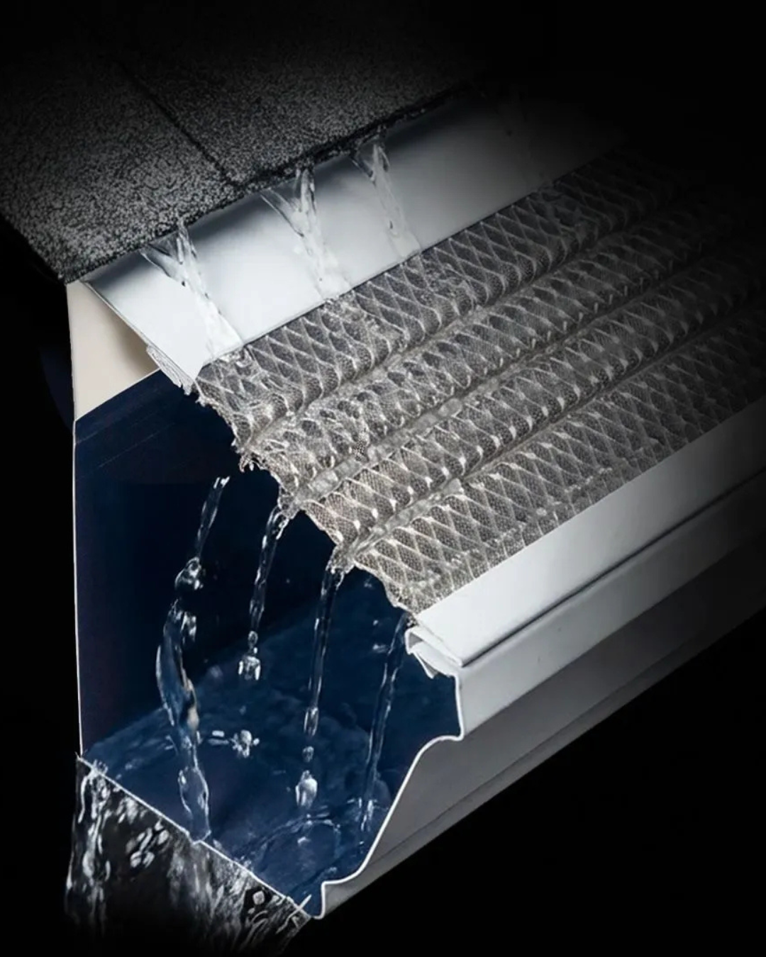 Close-up of a metal gutter overflowing with flowing water on a roof edge.