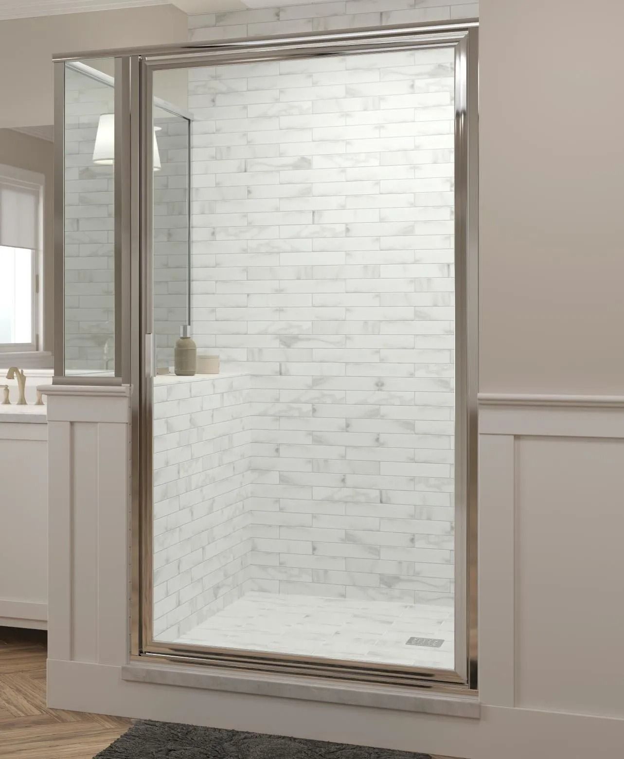 A walk-in shower with textured white brick-style walls, glass door, and a low curb in a light-colored bathroom.