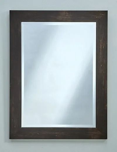 A rectangular mirror with a simple, dark brown wooden frame, centered against a plain light gray wall.
