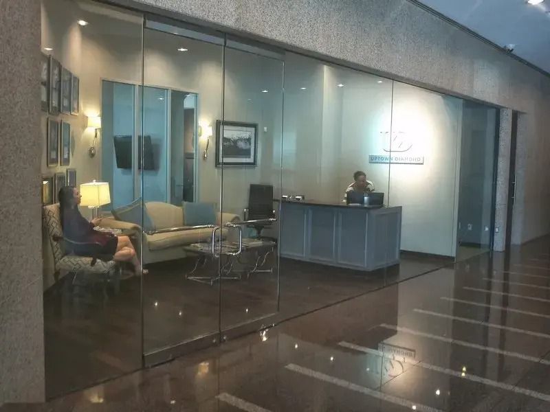 A lobby with a couch and chairs and a reception desk