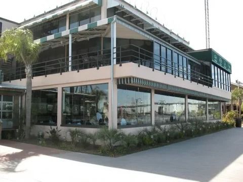 A large building with a lot of windows and a green awning.