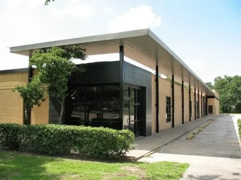 A large building with a covered walkway leading to it.
