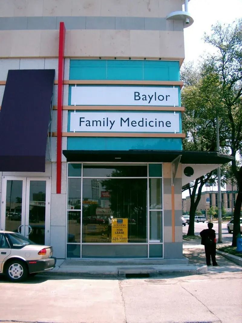 A baylor family medicine store with a car parked in front of it.