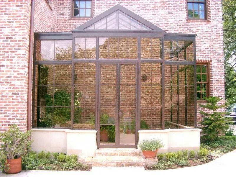 A brick house with a large glass entrance
