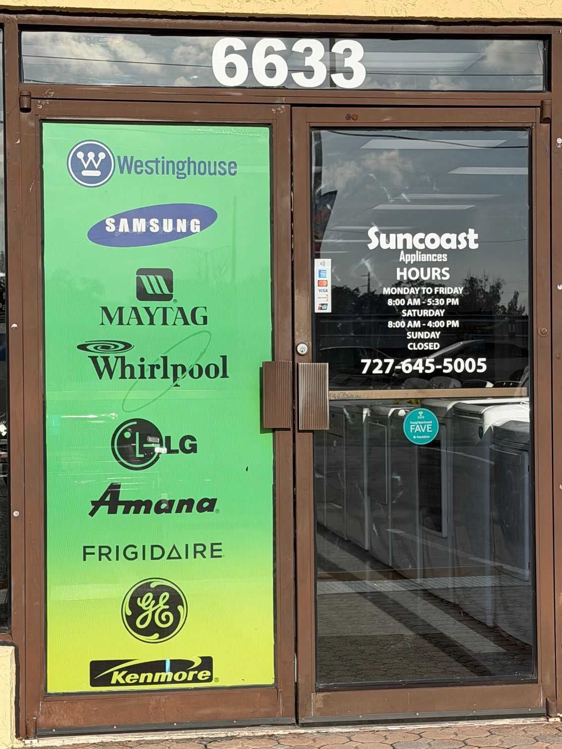 Glass storefront with green appliance logos and “Suncoast” hours, address 6633 above the door