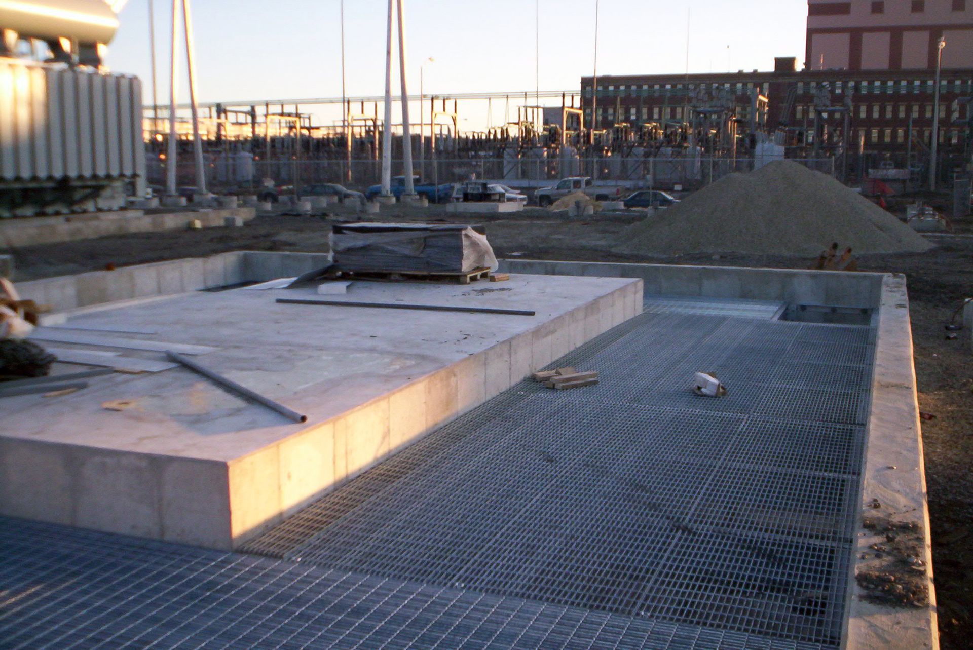 A construction site with a building in the background