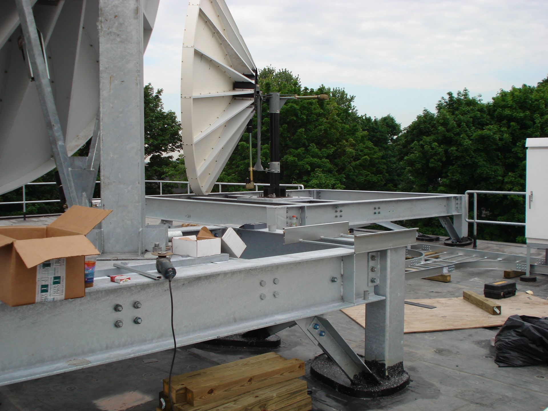 A satellite dish is being installed on the roof of a building
