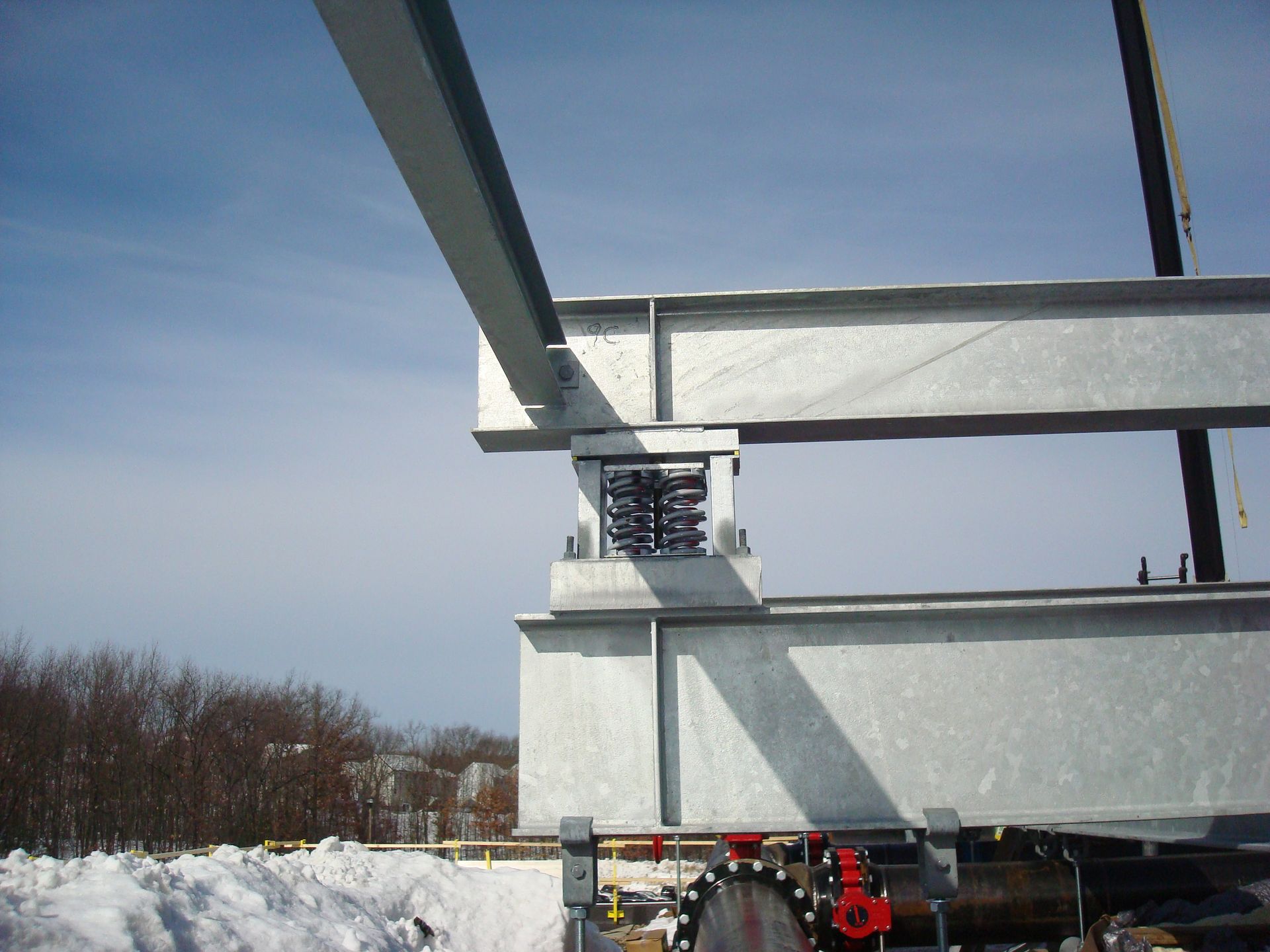 A metal structure is being built in the snow