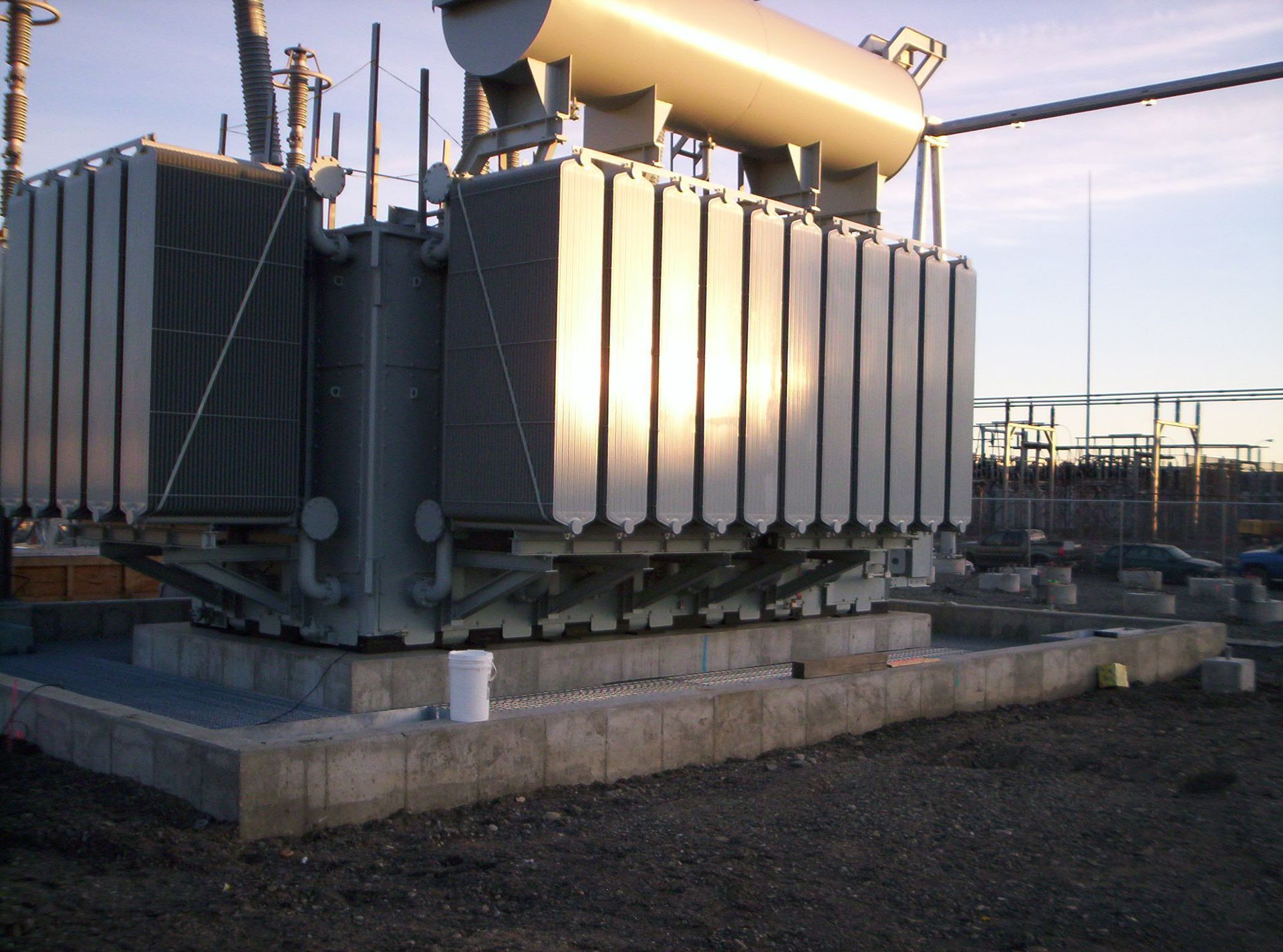 A large transformer is sitting on top of a concrete platform