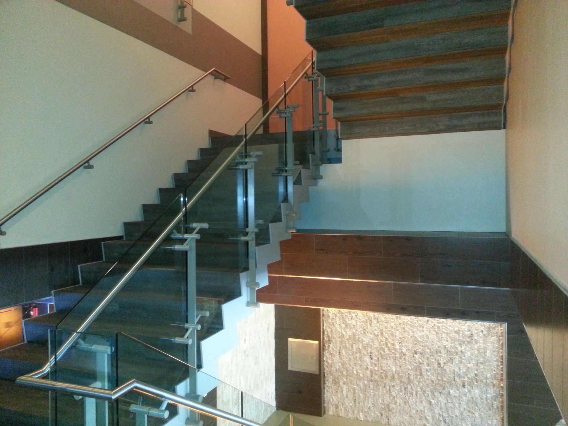 A staircase with a glass railing in a building