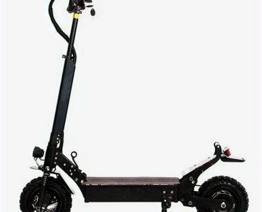 A black electric scooter is sitting on a white surface.
