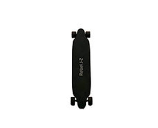 A black skateboard is sitting on a white surface.