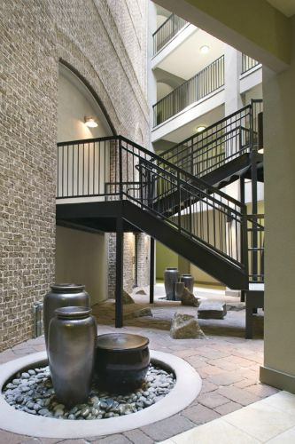 a building with stairs and a fountain in the middle