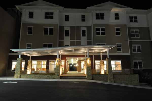 a large apartment building is lit up at night