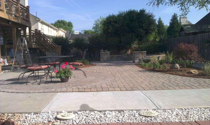 a patio with a table and chairs in the middle of it