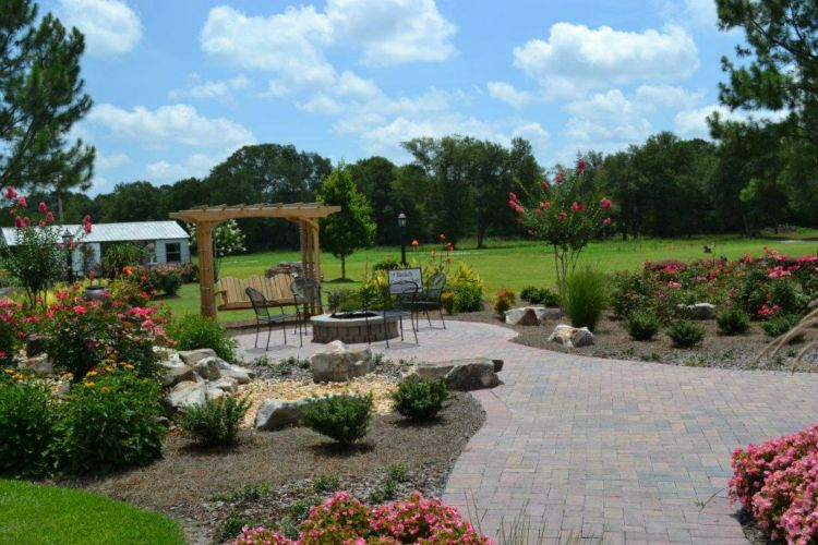 there is a fire pit in the middle of the garden .