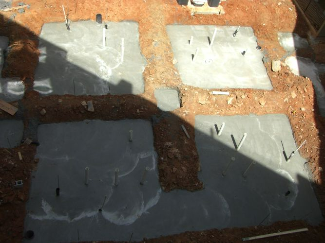 a concrete foundation is being built in a dirt area .