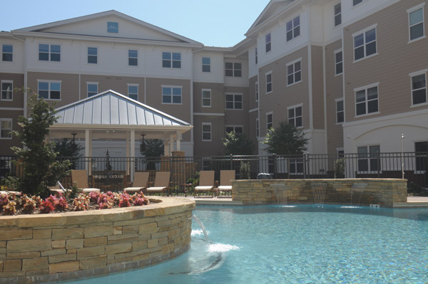 a large building with a swimming pool in front of it