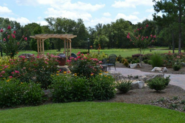 there is a pergola in the middle of the garden.
