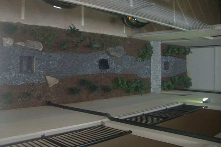 a bicycle is parked on the side of the road in a parking garage .