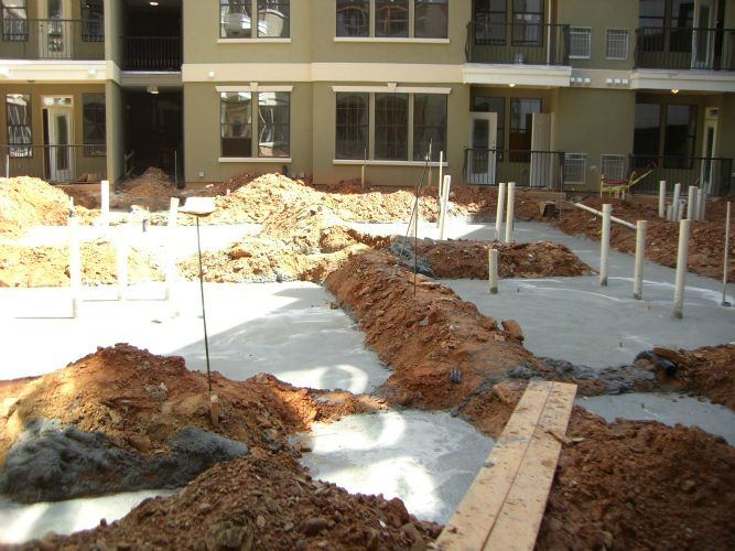 a large pile of dirt is in front of a building under construction