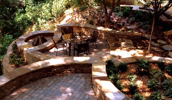 an aerial view of a patio with a table and chairs surrounded by trees .