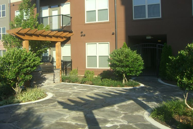 a large apartment building with a stone walkway leading to it